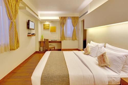 a bedroom with a large bed in a room at Whispering Palms Hotel Jaipur in Jaipur