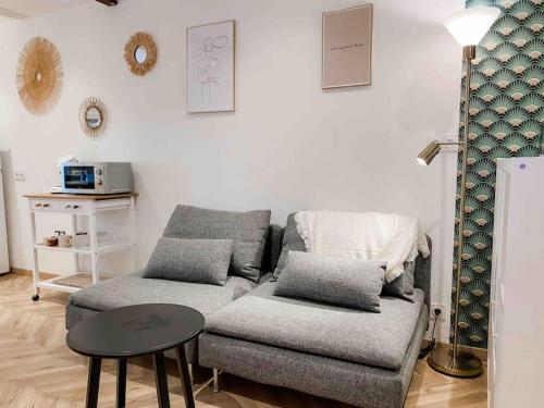 a living room with a couch and a table at Bonifacio : Studio au coeur de la citadelle in Bonifacio