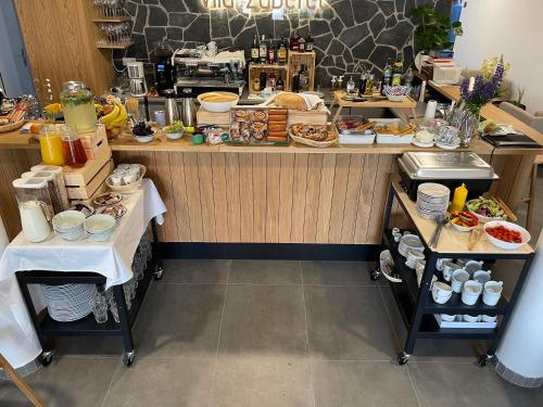 a restaurant with a counter with food on it at Zaži Apartmán Vila Zuberec in Zuberec