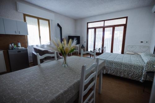 a kitchen and dining room with a table with flowers on it at B&B Da Annalisa in Marsala