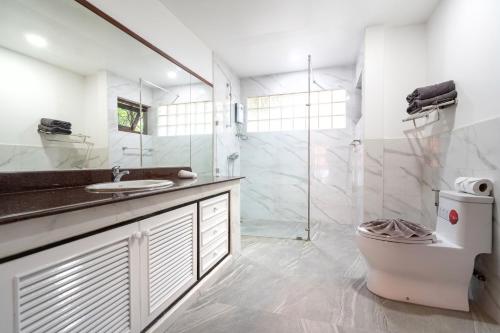 a bathroom with a sink and a shower and a toilet at Thai Style 2BR Villa in Nai Harn Beach