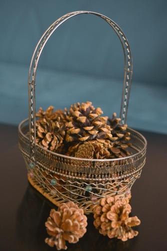 a basket filled with pine cones on a table at Surami Guest House - სახლი სურამში in Surami