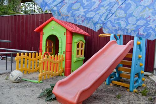 a playground with a slide and a play house at Surami Guest House - სახლი სურამში in Surami