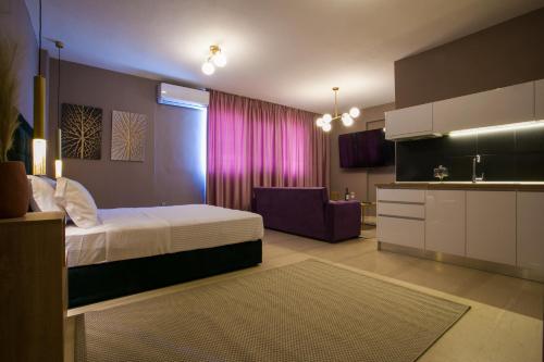 a bedroom with a bed and a kitchen with a sink at Marizas luxury suites #1 in Thessaloniki