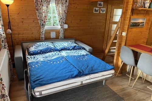 a bedroom with a bed with a blue comforter at Holiday home, Plau am See in Plau am See