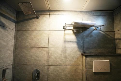 a bathroom with a towel on a towel rack at Hotel Townhouse at Udaipur City Railway Station in Udaipur