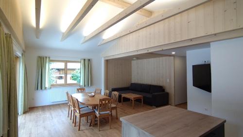 ein Wohnzimmer mit einem Tisch und einem Sofa in der Unterkunft Haslbauer in Steinbach am Attersee