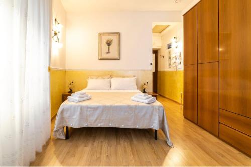 a bedroom with a bed with white sheets on it at B&B Borgo Antico in Cava deʼ Tirreni