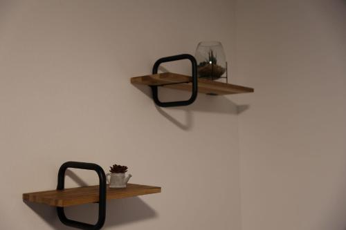 two wooden shelves on a white wall at Sorinas Home WB16 Top 12 in Wagersbach
