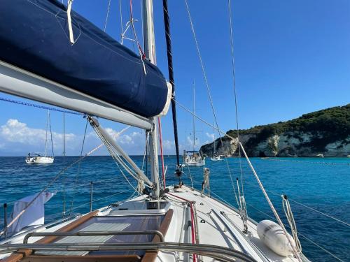 a boat in the ocean with other boats in the water at Swing in Corfu Town