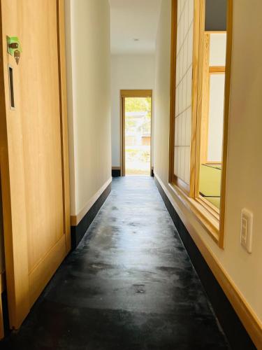 a hallway of an empty room with a door at ミロクハウス in Daisen