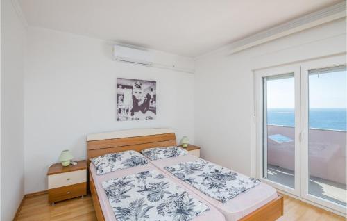 a bedroom with a bed and a large window at Nice Apartment In Stara Baska 1 With Wifi in Stara Baška