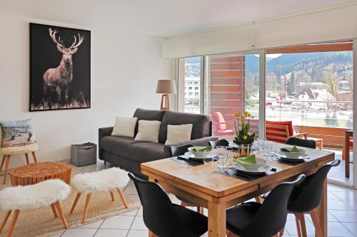 un salon avec une table et un canapé dans l'établissement Le Panoramic - Vue exceptionnelle, à Gérardmer