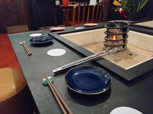 a table with bowls and chopsticks on top of it at 酒と宿と不動産-yado- in Yokosuka