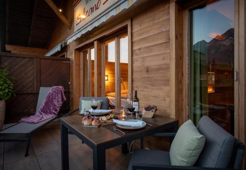 a dining room with a table and chairs on a balcony at SALZANO Apartments in Interlaken