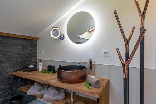 a bathroom with a wooden tub on a wooden counter at SALZANO Apartments in Interlaken