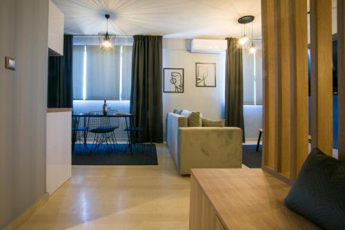 a living room with a couch and a table at marizas luxury suites #2 in Thessaloniki