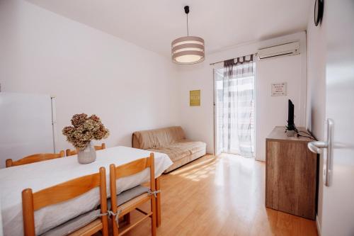 a living room with a table and a couch at Apartments Tončica in Božava