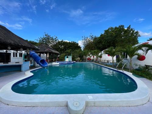 - une piscine avec toboggan dans un complexe dans l'établissement Binubusan Beach Hotel and Resort, à Lian