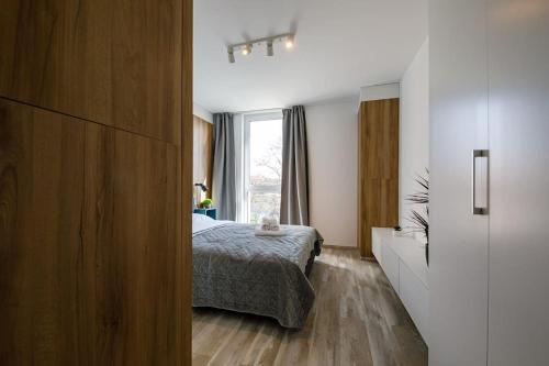 a bedroom with a bed and a window at Luxury Apt. Near River & Parking in Timişoara