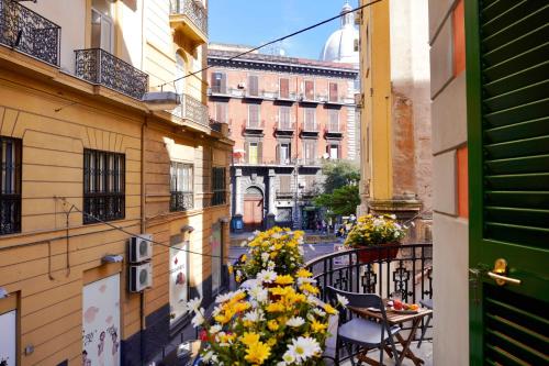 a balcony with flowers on a city street at Macchiato Suites Boutique Guest House in Naples