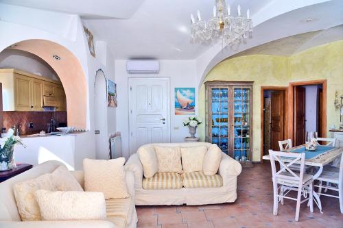 a living room with two white couches and a table at Case Vacanze La Conia in Cannigione