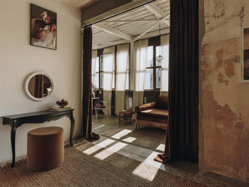 a living room with a table and a couch at Mona Athens in Athens