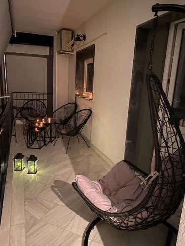 a room with a rocking chair and lights on the floor at M&F Meteora Apartments #2 in Kalabaka