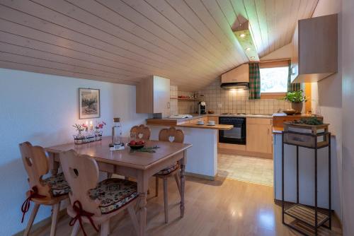 a kitchen with a table and chairs in a room at SALZANO Apartments in Interlaken