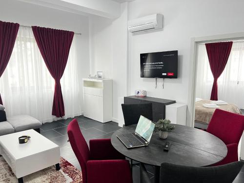 a living room with a table with a laptop on it at Cozy Aparthotel - Central City Suceava in Suceava