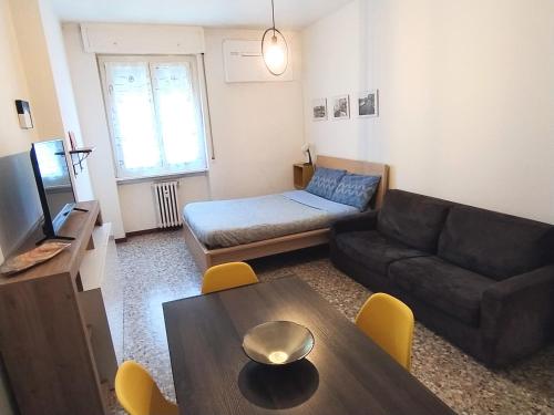 a living room with a couch and a table at Parsifal Apartment in Milan
