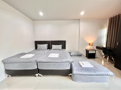 a bedroom with two beds and a television at Area15 Hotel & Apartment 