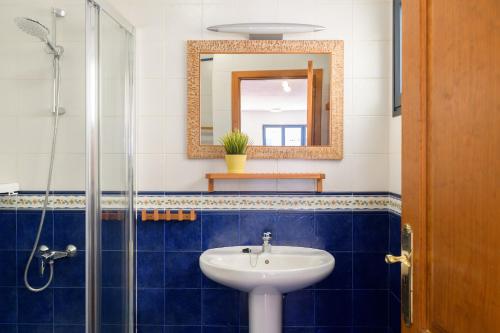 a bathroom with a sink and a mirror at Pleamar in Famara