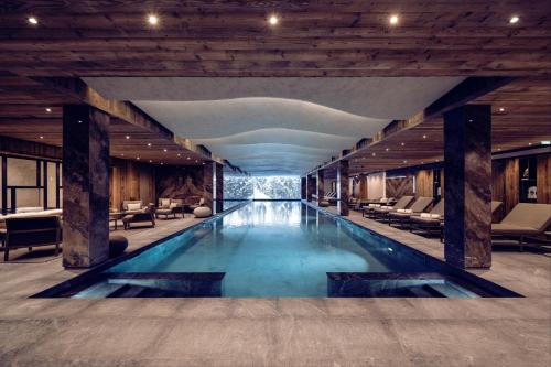 a pool in the middle of a building at Antarès Méribel Resort & SPA in Les Allues