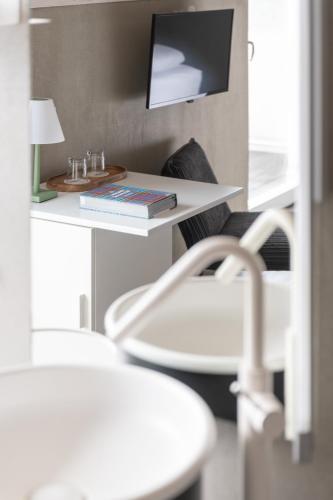 a room with a white table and a chair at Hotel Baia Azzurra - Lake Front in Nago-Torbole