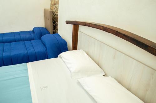 a close up of a bed in a room at Palazzo Iaquinta - Rooms, Restaurant & Wellness in Cicerale