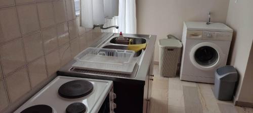 a small kitchen with a sink and a washing machine at 3 Brothers IV in Tríkala