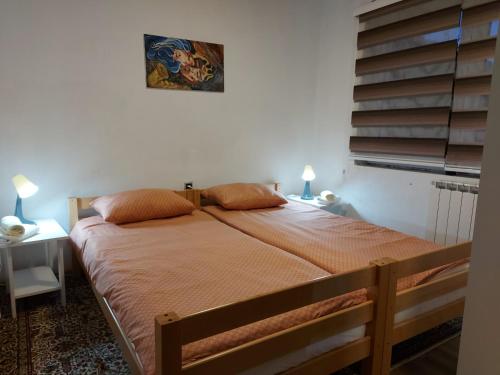 a bedroom with a large bed with orange sheets at Luxury house "Heart of Nature" Visoko in Visoko