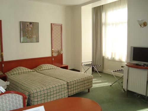 Säng eller sängar i ett rum på Hotel Le Dome
