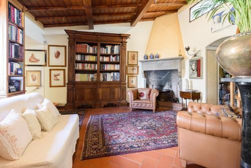 a living room with a couch and a fireplace at Residenza del Bravo by Mmega in Impruneta