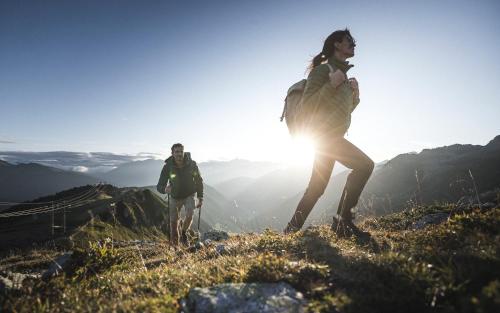 a man and a woman standing on top of a mountain at Hotel Schölzhorn Superior in Racines