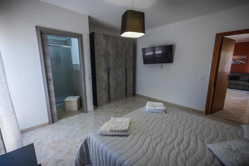 a bedroom with a bed with two towels on it at Sole & Luna Apartment in Marsala