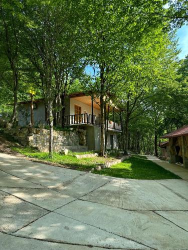 a house with a balcony on the side of a road at Martvili canyon cottage in Martvili