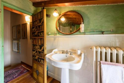 a bathroom with a sink and a mirror at Residenza del Bravo by Mmega in Impruneta