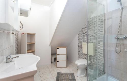 a bathroom with a toilet and a glass shower at Lovely Apartment In Stara Baska 1 With Kitchen in Stara Baška