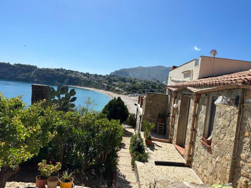 a house with a view of a river and a building at Terrazza sul mare Scopello in Scopello