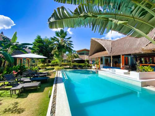 an image of a swimming pool at a resort at Villa Kasadya in Panglao Island