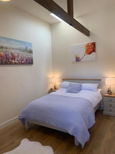 1 dormitorio con 1 cama y una pintura en la pared en Barford barn holiday cottage, en Darlington