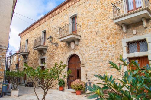 a building with balconies on the side of it at Palazzo Iaquinta - Rooms, Restaurant & Wellness in Cicerale