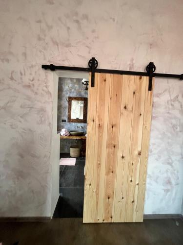 a wooden door in a room with a wall at Apartmány v Podzámčí v blízkosti zámku Blatná in Blatná